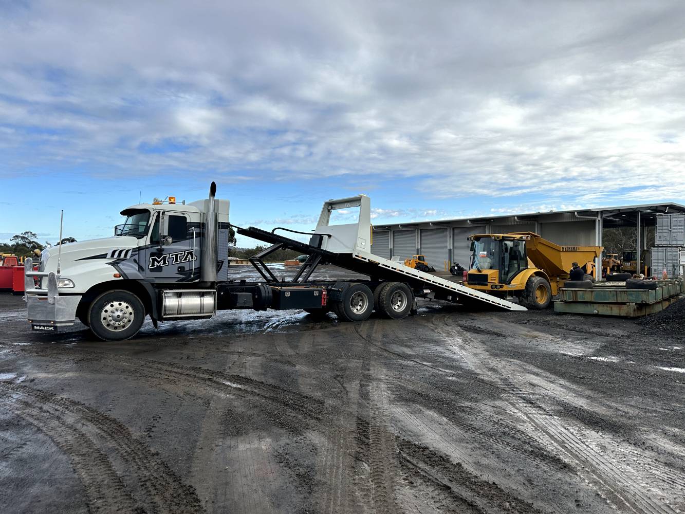 heavy haulage and machine transportation central coast ready to take a dirt mover